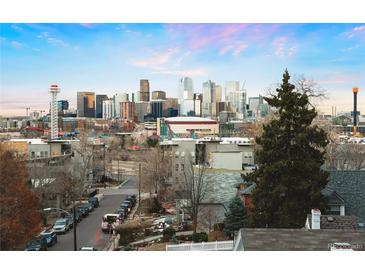 Breathtaking downtown city view showcasing the skyline over neighborhood buildings and tree lined street at 2240 N Clay St # 501, Denver, CO 80211