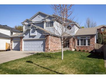 Charming two-story home with a well-manicured lawn, a two-car garage, and appealing architectural details at 1009 Monarch Way, Superior, CO 80027