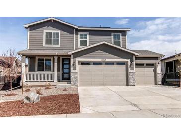 Charming two-story home featuring a three-car garage, well-maintained yard and welcoming front porch at 27615 E Archer Ave, Aurora, CO 80018