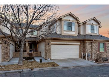 Charming townhouse features a two-car garage and a mix of brick and neutral siding at 3035 S Indiana St, Lakewood, CO 80228