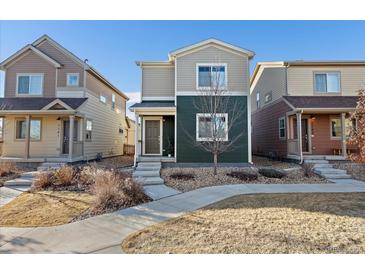 Charming two-story home with a well-maintained yard and inviting walkway to the front door at 1143 Hummingbird Cir, Longmont, CO 80501