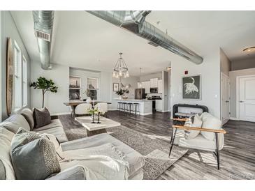 Bright living room with hardwood floors, modern furniture, and large windows at 277 N Broadway # 208, Denver, CO 80203