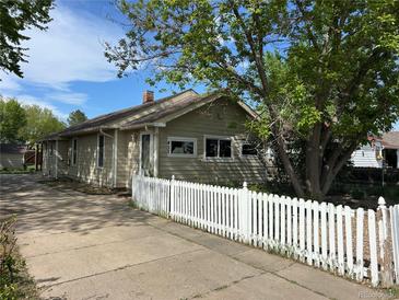 Charming single-story home with a well-maintained yard and a classic white picket fence at 437 6Th St, Frederick, CO 80530