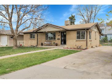 Charming brick ranch home with a well-manicured lawn and inviting front porch at 4108 S Inca St, Englewood, CO 80110
