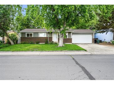 Charming single-story home with a well-manicured front lawn and attached two car garage at 11625 Bellaire Way, Thornton, CO 80233