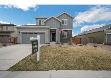 Charming two-story home with manicured lawn, a two-car garage, and a For Sale sign at 6954 E 117Th Ave, Thornton, CO 80233