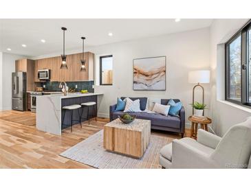 Bright and airy living room featuring hardwood floors, a modern coffee table, and comfortable seating at 1715 Grove St, Denver, CO 80204