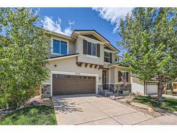 Charming two-story home boasts a two-car garage, well-maintained landscaping, and inviting curb appeal in a friendly neighborhood at 10528 Applebrook Cir, Highlands Ranch, CO 80130