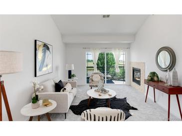 Bright living room featuring a cozy fireplace, stylish furniture, and balcony access with scenic views at 804 Summer Hawk Dr # 7301, Longmont, CO 80504