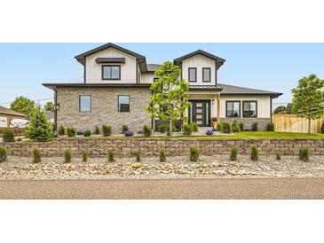 Beautiful two-story home with stone accents, manicured landscaping, and a charming modern farmhouse design at 8623 S Wadsworth Ct, Littleton, CO 80128