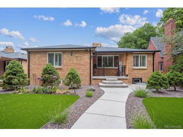 Charming brick home features a well-manicured lawn, walkway, and inviting front porch at 2664 Forest St, Denver, CO 80207