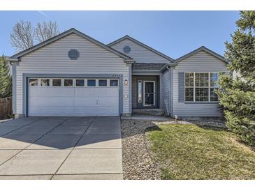 Charming single-Gathering home featuring a two-car garage, manicured lawn, and inviting entrance at 20344 Heather Ln, Parker, CO 80138
