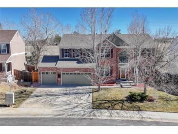 Charming two-story brick home featuring a spacious driveway and a well-manicured front yard at 11730 Crow Hill Dr, Parker, CO 80134