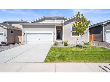 Charming single-Gathering home with a well-maintained lawn, two car garage, and inviting curb appeal at 819 Sunflower Dr, Brighton, CO 80601