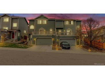 Charming townhome with attached garages, front decks, and lush landscaping at 1552 Live Oak Rd, Castle Rock, CO 80104