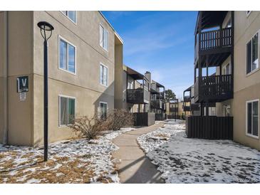 Exterior view of building showcasing landscaping and walkway at 9725 E Harvard Ave # 349, Denver, CO 80231