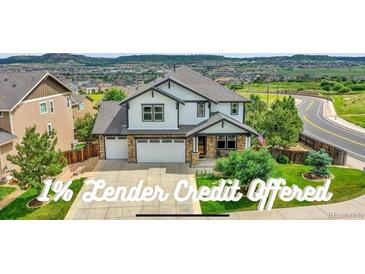 Beautiful two-story home boasts a two-car garage, manicured lawn, and attractive landscaping at 2314 Fairway Wood Cir, Castle Rock, CO 80109