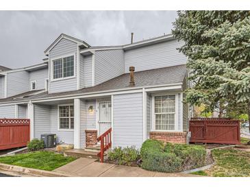 Charming two-story townhome with light blue siding, well-maintained landscaping, and a welcoming entrance at 12282 Bannock Cir # A, Denver, CO 80234
