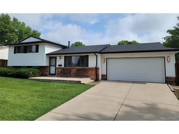 Charming two-story home with a well-manicured lawn, front porch, and a two car garage at 315 E 112Th Dr, Northglenn, CO 80233