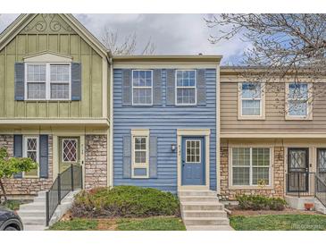 Charming townhome featuring colorful siding, complemented by well-maintained landscaping and a welcoming front entrance at 8197 S Fillmore Way, Centennial, CO 80122