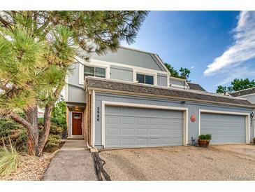 Charming townhome showcasing a two-car garage and well-maintained landscaping at 2980 S Parker Ct, Aurora, CO 80014