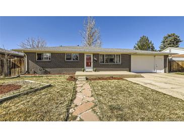 Charming brick home with a well-maintained front yard, stone pathway and a red front door, offering great curb appeal at 8361 Mason Cir, Westminster, CO 80031