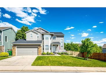 Charming two-story home with a well-manicured lawn and attached two-car garage at 1932 Sandhurst Dr, Castle Rock, CO 80104