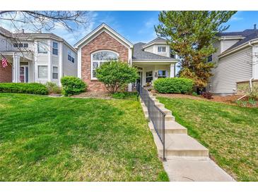 Inviting two-story home with a landscaped front yard and concrete steps leading to the entryway at 1011 S Valentia St # 30, Denver, CO 80247
