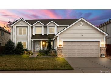 Charming two-story home featuring a well-manicured lawn and an attached two-car garage at 5745 S Andes St, Aurora, CO 80015