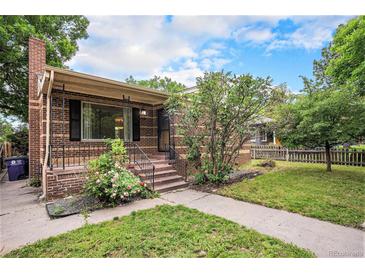 Charming brick home featuring a well-maintained lawn and inviting front porch at 2526 W 39Th Ave, Denver, CO 80211