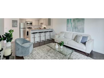 Bright living room featuring sleek furniture, modern decor, and an open floor plan into the kitchen at 5120 Williams Fork Trl # 210, Boulder, CO 80301