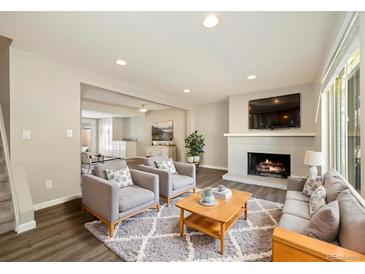 Inviting living room featuring a fireplace, two chairs, a couch and recessed lighting at 13003 W 20Th Ave, Golden, CO 80401