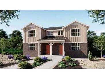 Charming two-story home with a well-manicured lawn and a welcoming entryway with eye-catching orange doors at 24126 E 53Rd Dr, Aurora, CO 80019