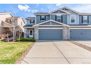 Charming two-story townhome featuring stone accents, a two-car garage, and well-maintained landscaping at 6276 Turnstone Pl, Castle Rock, CO 80104