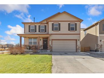 Charming two-story home featuring a two-car garage, front porch, and neutral exterior paint at 567 Jewel St, Brighton, CO 80603