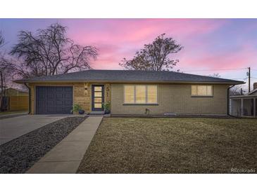 Charming ranch-style home with a brick facade, wood accents, and a well-maintained front yard at 51 S Eaton St, Lakewood, CO 80226