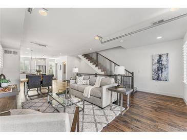 Bright living room with hardwood floors and a comfortable sofa at 163 S Harrison St, Denver, CO 80209