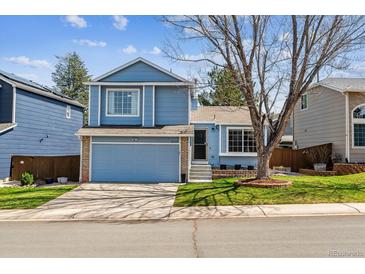 Charming two-story home with a well-maintained lawn, a two-car garage, and lovely curb appeal at 10518 Hyacinth Pl, Highlands Ranch, CO 80129
