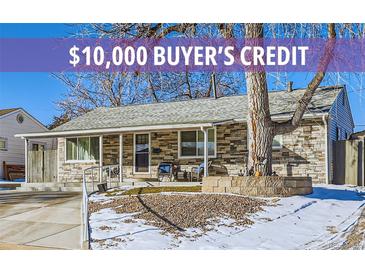 Charming single-story home featuring a stone facade, and a well-maintained front yard landscape at 2701 S Knox Ct, Denver, CO 80236