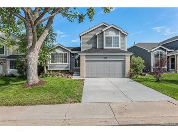 Charming two-story home with a well-maintained lawn, mature tree and attached two car garage at 5068 E Crestone Ave, Castle Rock, CO 80104