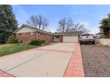 Charming single-story brick home with a spacious driveway and attached two-car garage at 748 W 100Th Ave, Northglenn, CO 80260
