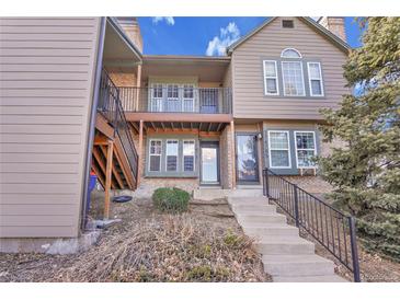 Inviting two-story townhome featuring a cozy balcony, a welcoming entrance, and traditional architectural charm at 17478 E Rice Cir # D, Aurora, CO 80015