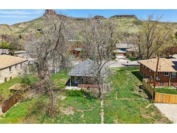 Charming bungalow with a front yard, mature trees, and mountain views at 1914 Washington Ave, Golden, CO 80401