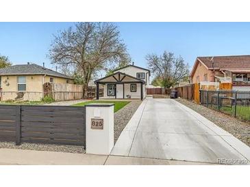 Charming home exterior featuring a long driveway and well-maintained landscaping at 825 S Quitman St, Denver, CO 80219