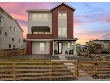 Charming two-story home featuring a modern design, front porch, and a neatly landscaped yard at 938 Hearteye Trl, Lafayette, CO 80026