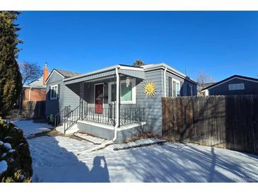 Charming bungalow with gray siding, a red door, and a covered porch at 2480 S Bannock St, Denver, CO 80223