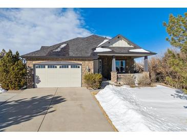 Beautiful ranch home with stone accents and a large front porch at 7260 Fallon Cir, Castle Rock, CO 80104