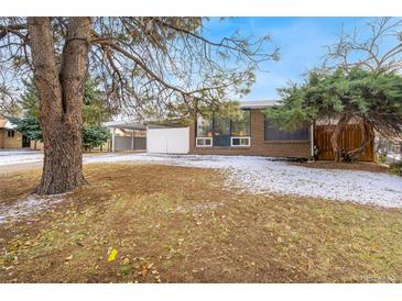 Ranch style home with mature landscaping and a spacious front yard at 383 S Vaughn Way, Aurora, CO 80012