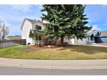 Charming two-story home with mature landscaping and well-maintained front yard at 11976 W Brandt Pl, Littleton, CO 80127