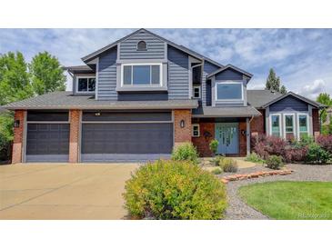 Beautiful two-story home with brick and blue siding, large garage, and well-maintained landscaping at 7831 W 109Th Ave, Westminster, CO 80021